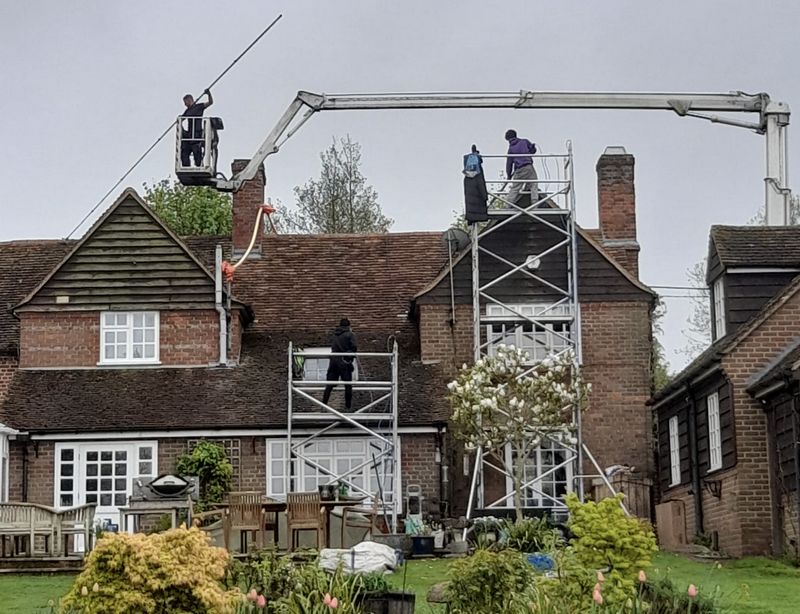 The Moss Cleaners using cherry picker and scaffolding to clean roof safely and professionally in Earlsfield, London